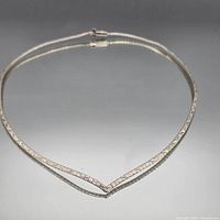 Full view of sterling silver omega choker necklace arranged in V shape