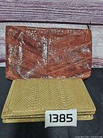 Both clutches shown, brown behind, tan in front