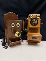 Both wall telephones side by side showing overall condition and included handset