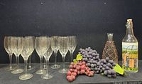 Full lot showing 10 wine glasses, decanter, ice water bottle, two grape bunches