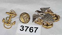 Lot overview showing cap crest, anchor insignia, button