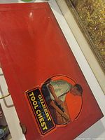 Top of red metal chest with exterior decal
