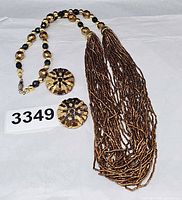 Entire set laid out: necklace coiled beside matching earrings