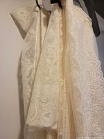 Multiple cream lace panels on hangers