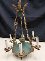Full view of chandelier showing green bowl, five arms, chains, canopy