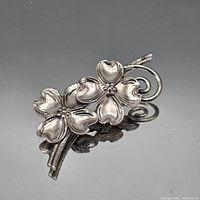 Front view of sterling floral brooch showing design and patina