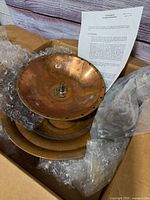 Copper bowls, bubble wrap, instruction sheet visible in box