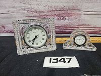 Both Waterford crystal clocks side by side with scale reference