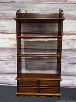 front view of full wall shelf showing shelves and drawers