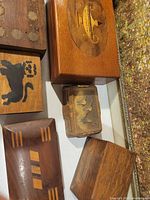 Group shot showing five wooden boxes/tray, highlighting inlaid and carved designs