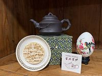 Teapot on storage box with certificate visible