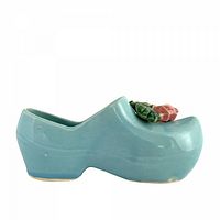 Left profile of blue ceramic Dutch shoe planter with rose detail