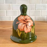 Front view showing peach hibiscus design and green glaze