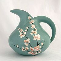 Front view showing painted blossom decoration and pitcher form