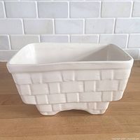 angled view of white basket-weave planter