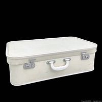 Top and side view showing ivory hard case, chrome latches, white handle