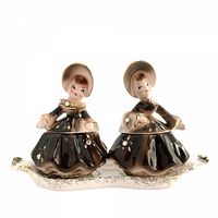 Front view of both girl-shaped shakers on tray