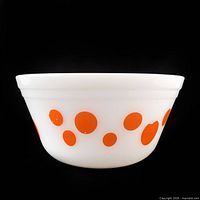 Side view of white milk glass bowl showing orange dot pattern
