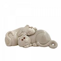 Front view of both white ceramic cat shakers forming a resting duo