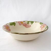 Side view of Franciscan Desert Rose ceramic serving bowl showing hand-painted floral rim and brown edge