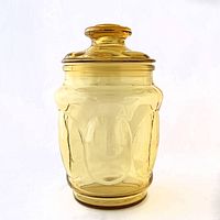 Front view of honey gold thumbprint glass canister with lid
