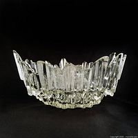 Side view of clear jagged-rim ice glass bowl