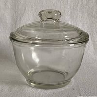 Full view of clear pressed glass bowl with lid in place