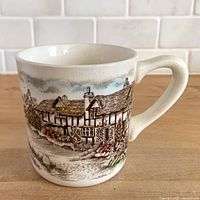 Front view of ironstone mug showing countryside scene and crazing
