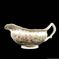 Right side view of gravy boat showing transferware scene and overall form