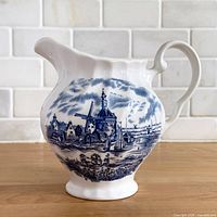 Front view of creamer showing transferware scene and overall shape