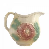 Front view showing floral relief and spout