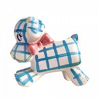 Left side view of ceramic puppy dog planter showing blue plaid pattern and pink bow