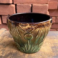 Front view showing celestial embossing and drip glaze