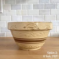 Profile view of bowl showing brown stripes and pie-crust rim