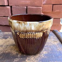 Front view showing brown drip glaze and ribbed design