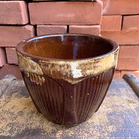Front view of brown drip glaze stoneware jardiniere showing ribbed Gothic pattern
