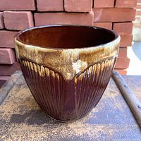 Front view of brown drip glazed stoneware jardiniere showing ribbed design