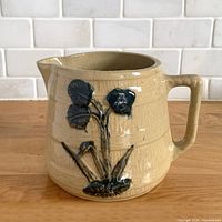 Front view showing lily decoration and barrel form