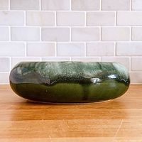 Front view of oval green drip-glaze planter