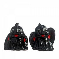 Front view of both black elephant shakers showing painted details