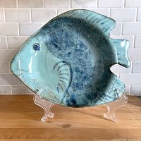 Front view of fish-shaped glazed platter showing color, texture and form