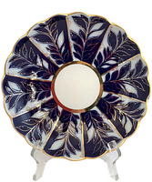 Front view of scalloped porcelain dish showing cobalt leaf pattern and gold detailing