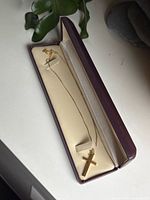 Entire necklace with cross pendant displayed inside hinged box