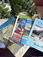Stacked view showing Lake Louise, Mount Rushmore, Waikiki and other brochures
