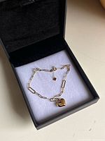 Bracelet in box showing full chain and heart charm
