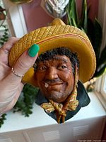 Front view showing facial details and missing cigar