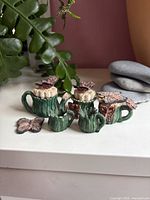 Group shot of all six ceramic miniatures on tabletop