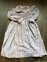Full view of lavender smocked dress laid flat