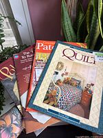 Stack of four craft magazines/booklets showing covers