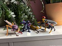 Group shot of all five figures on shelf